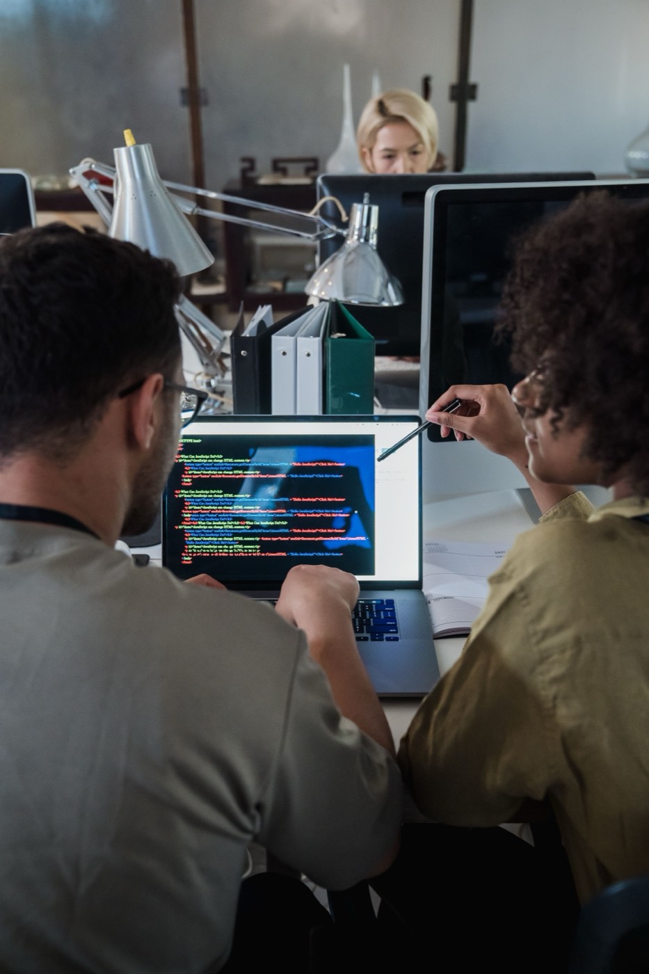 Two developers reviewing code together on one screen